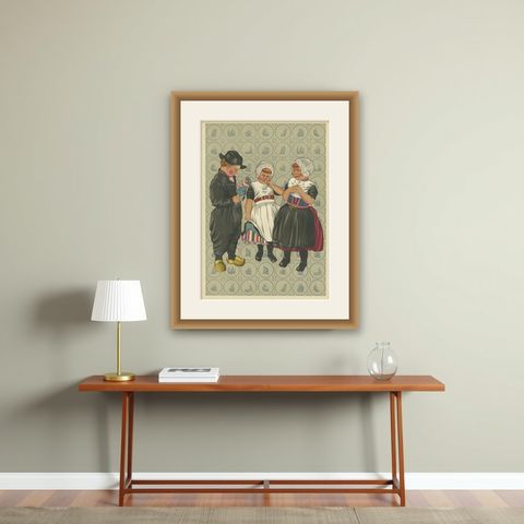 Children’s Traditional Dress from Urk with Embroidered Aprons and Silver Details, shown framed on a wall
