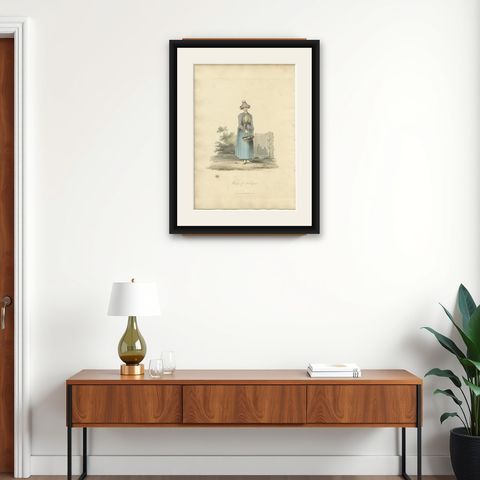 Antique Costume Print of a Frisian Woman from Hindelopen, the Netherlands, 1817, shown framed on a wall